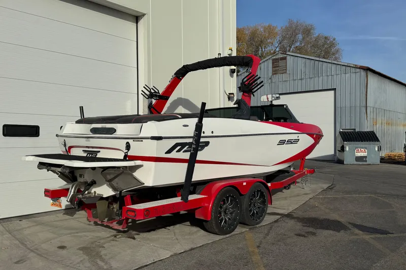 Slide: The Image of 2020 MB B52 23 Classic boat on trailer near industrial building. - 1