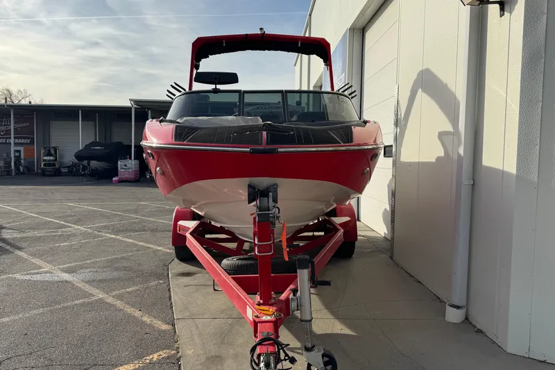 Slide: The Image of Red 2020 MB B52 23 Classic boat on trailer, parked outside a building. - 4