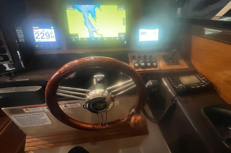 Slide: The Image of 2020 Ranger Tugs R-27 Luxury Edition Tug helm with navigation screens and controls. - 10