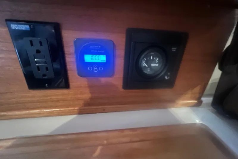 Slide: The Image of 2020 Ranger Tugs R-27 Luxury Edition Tug interior control panel with outlets and gauges. - 12