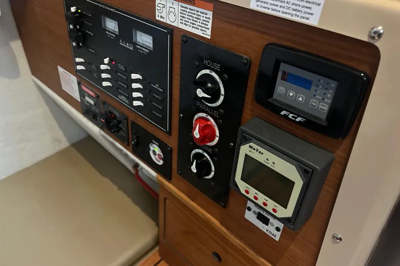 Slide: The Image of Control panel of 2020 Ranger Tugs R-27 Luxury Edition Tug with various switches and meters. - 14