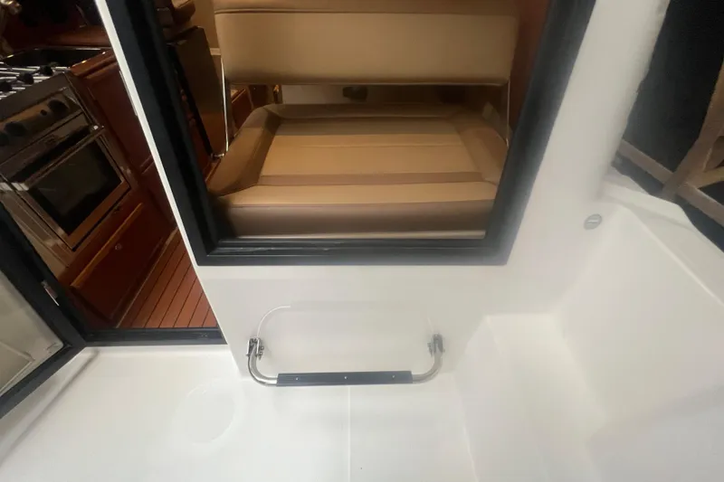 Slide: The Image of Interior view of 2020 Ranger Tugs R-27 Luxury Edition Tug, featuring seating and kitchen area. - 16