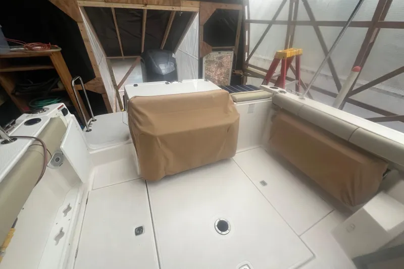 Slide: The Image of 2020 Ranger Tugs R-27 Luxury Edition Tug interior with covered seating and storage. - 20