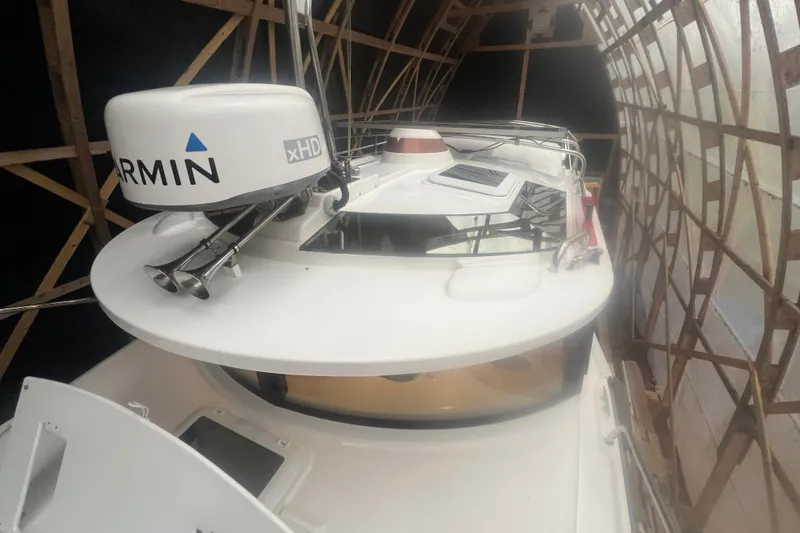 Slide: The Image of 2020 Ranger Tugs R-27 Luxury Edition Tug in storage, featuring Garmin xHD radar. - 22