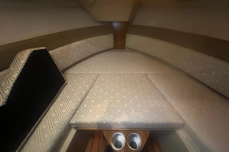 Slide: The Image of 2020 Ranger Tugs R-27 Luxury Edition Tug interior with patterned cushions and wood accents. - 7