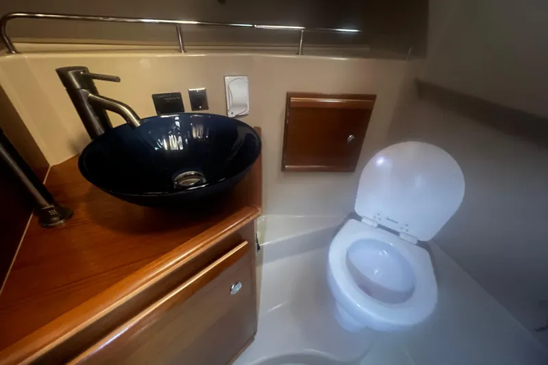 Slide: The Image of 2020 Ranger Tugs R-27 Luxury Edition Tug bathroom with modern sink and toilet. - 8
