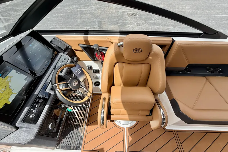 Slide: The Image of 2026 Cobalt R8 Outboard boat interior with tan leather seating and modern dashboard controls. - 17