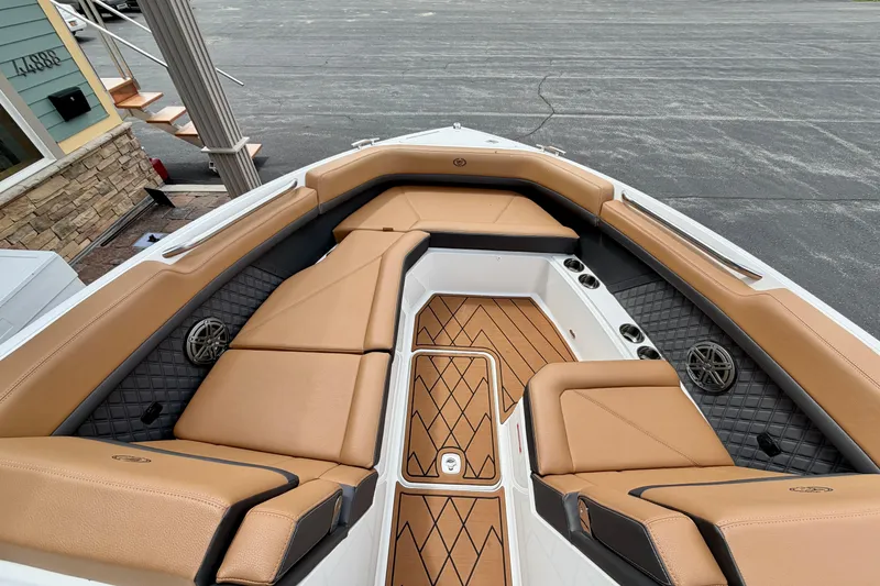 Slide: The Image of Luxurious interior of 2026 Cobalt R8 Outboard boat with tan seating and wood accents. - 24