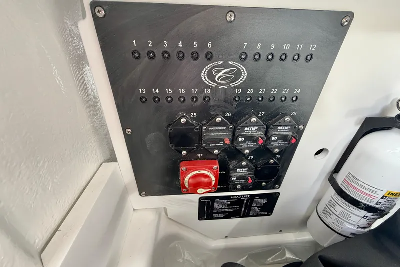 Slide: The Image of Control panel of 2026 Cobalt R8 Outboard boat with switches and fire extinguisher. - 29