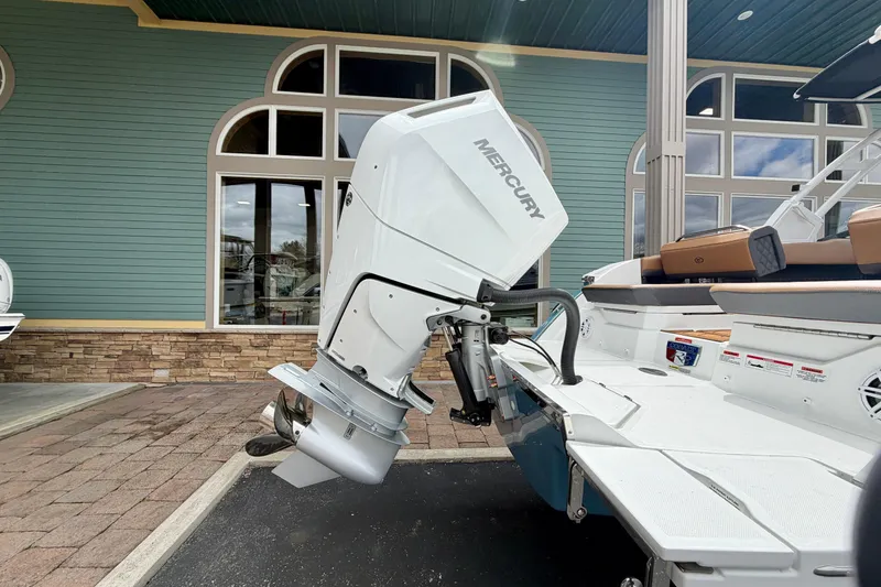 Slide: The Image of 2026 Cobalt R8 Outboard boat with Mercury engine, docked near a building. - 32