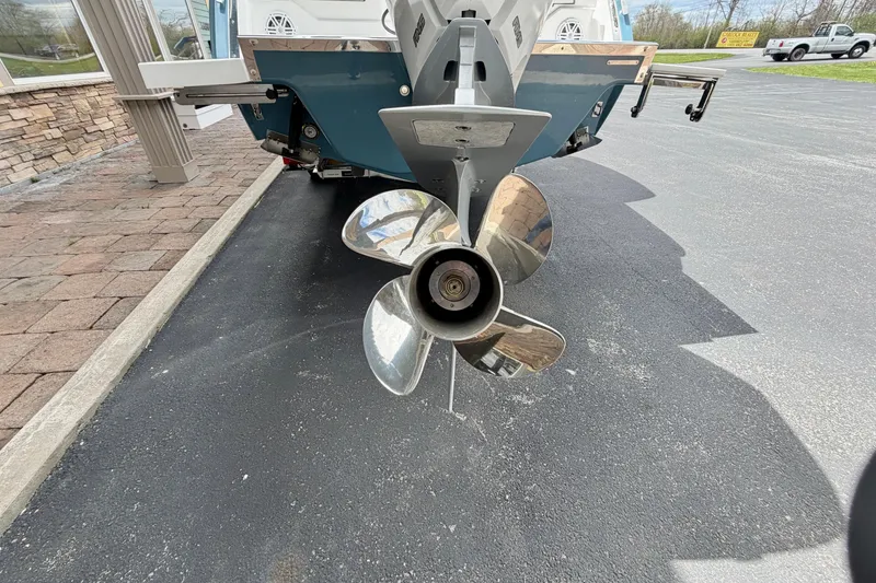 Slide: The Image of 2026 Cobalt R8 Outboard boat propeller on display in a parking lot. - 33