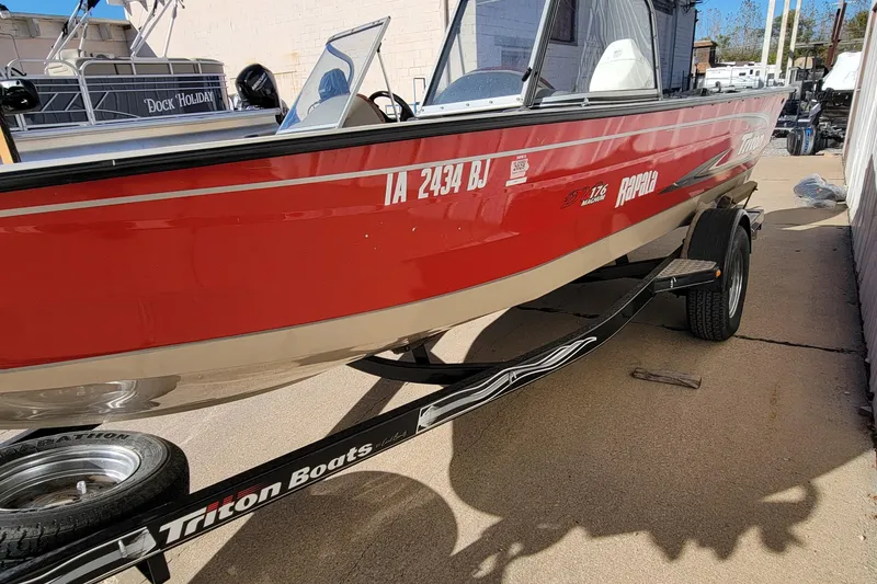 Slide: The Image of 2007 Triton DV 176 Mag red boat on trailer, parked outdoors. - 10