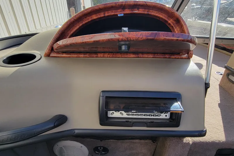 Slide: The Image of 2007 Triton DV 176 Mag dashboard with wood trim and stereo system. - 19