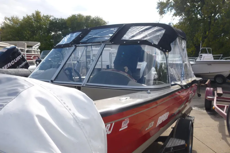 Slide: The Image of 2007 Triton DV 176 Mag boat with canopy, parked on a trailer. - 23