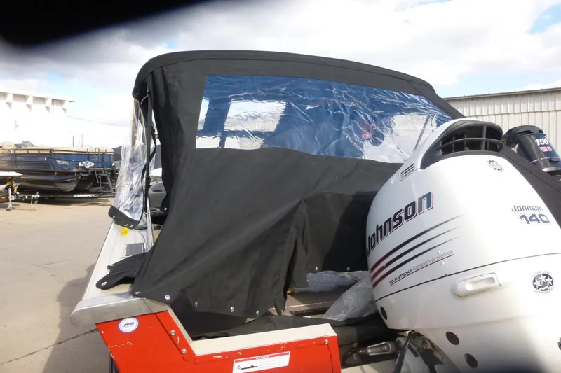 Slide: The Image of 2007 Triton DV 176 Mag boat with Johnson 140 outboard motor, covered and docked. - 25