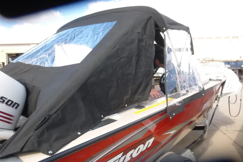 Slide: The Image of 2007 Triton DV 176 Mag boat with black canopy and Johnson outboard motor. - 26