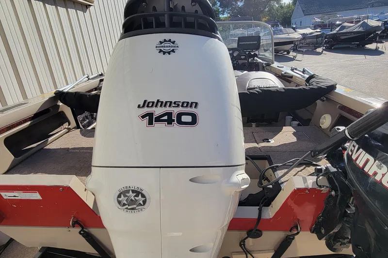 Slide: The Image of 2007 Triton DV 176 Mag boat with Johnson 140 outboard motor in a marina setting. - 4