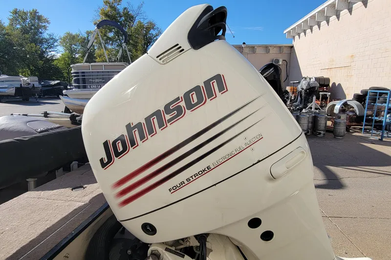 Slide: The Image of 2007 Triton DV 176 Mag with Johnson four-stroke outboard motor in a boatyard. - 5