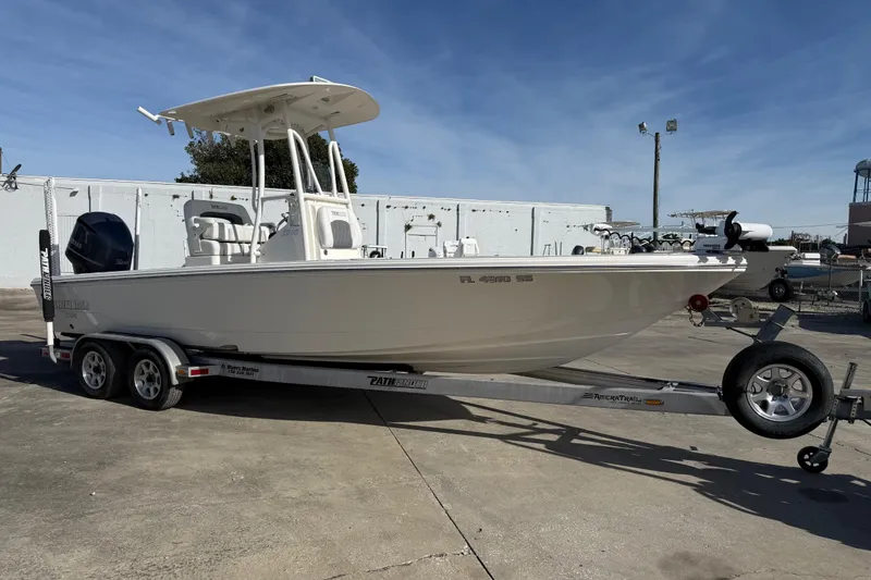 The Image of 2021 Pathfinder 2500 Hybrid boat on trailer, parked outdoors under clear sky. - 0
