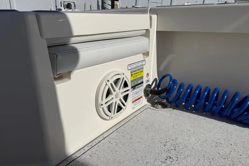 Slide: The Image of 2021 Pathfinder 2500 Hybrid boat interior with speaker and blue coiled hose. - 13