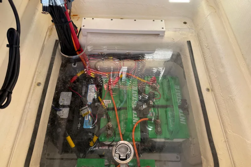 Slide: The Image of Battery compartment of a 2021 Pathfinder 2500 Hybrid boat, showcasing wiring and connections. - 19