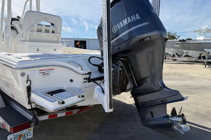 Slide: The Image of 2021 Pathfinder 2500 Hybrid boat with Yamaha outboard motor, parked on a trailer. - 23