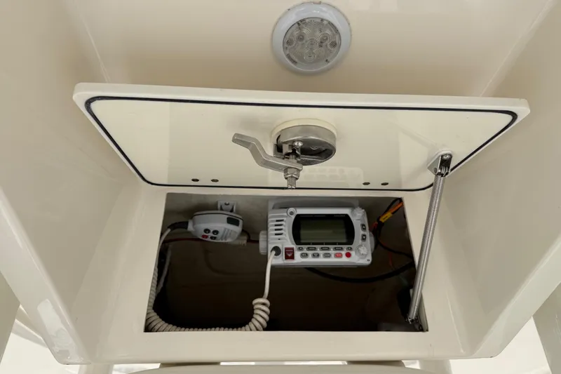 Slide: The Image of 2021 Pathfinder 2500 Hybrid boat console with electronic equipment and storage compartment. - 9