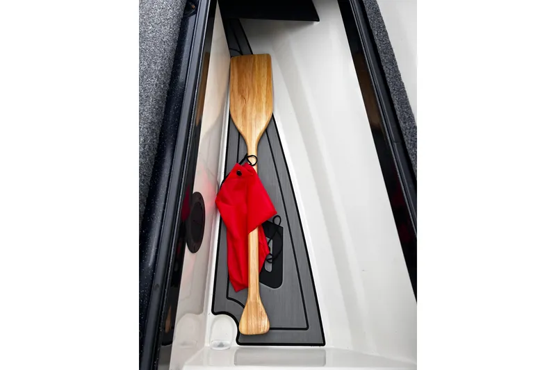 Slide: The Image of Wooden paddle with red cloth in 2023 Ranger Z520R boat compartment. - 10
