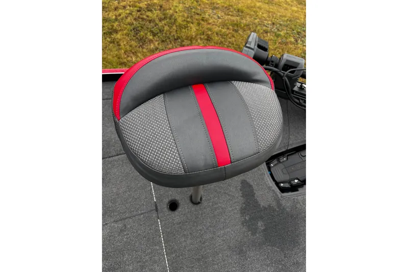 Slide: The Image of 2023 Ranger Z520R boat seat with red and gray design, on deck. - 13