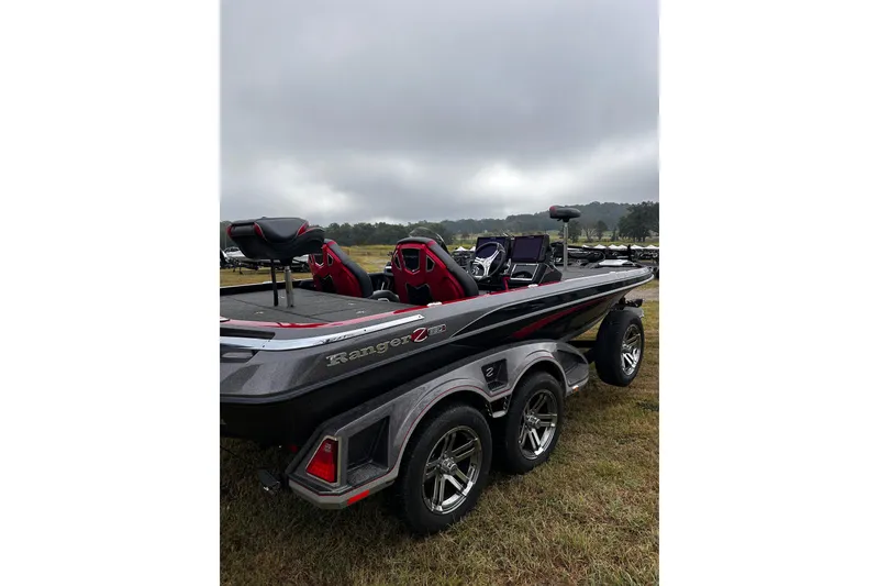 Slide: The Image of 2023 Ranger Z520R Ranger Cup Equipped boat on grassy field under cloudy sky. - 18