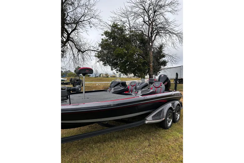 Slide: The Image of 2023 Ranger Z520R Ranger Cup Equipped boat on grass, showcasing sleek design and seating. - 19