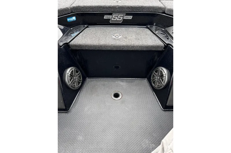 Slide: The Image of 2023 Ranger Z520R Ranger Cup boat interior with speakers and carpeted surfaces. - 2