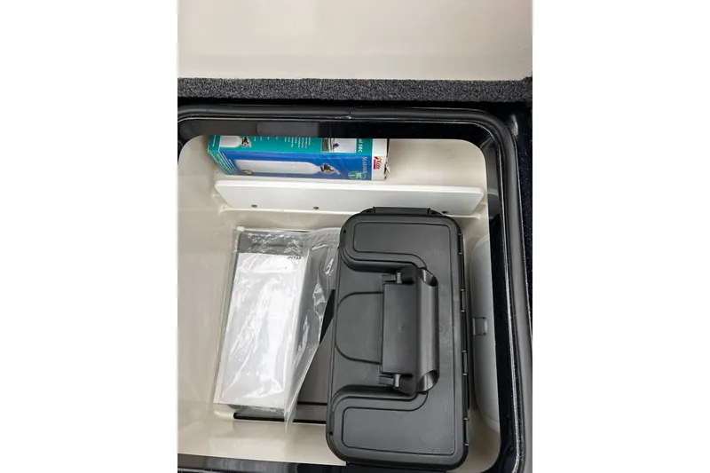 Slide: The Image of Storage compartment in 2023 Ranger Z520R Ranger Cup Equipped boat, containing various items. - 4