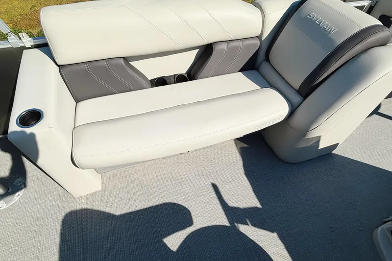 Slide: The Image of 2020 Sylvan Mirage Fish 820 with Honda outboard motor, parked near a building. - 13