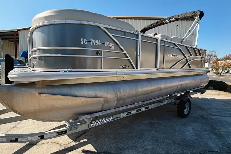 Slide: The Image of 2020 Sylvan Mirage Fish 820 Party Fish pontoon boat on trailer, with Honda outboard motor. - 2