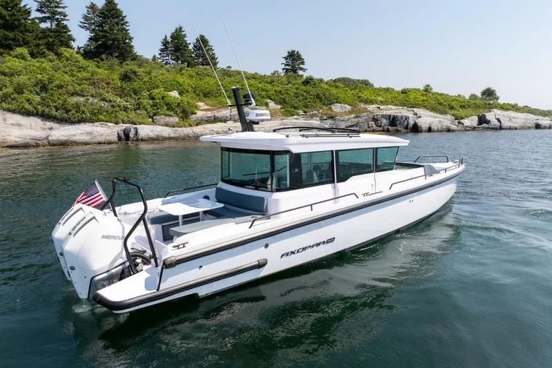 Slide: The Image of 2026 Axopar 37 U-Sofa boat on calm water. - 12