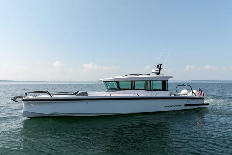 Slide: The Image of 2026 Axopar 37 U-Sofa boat on calm water. - 13