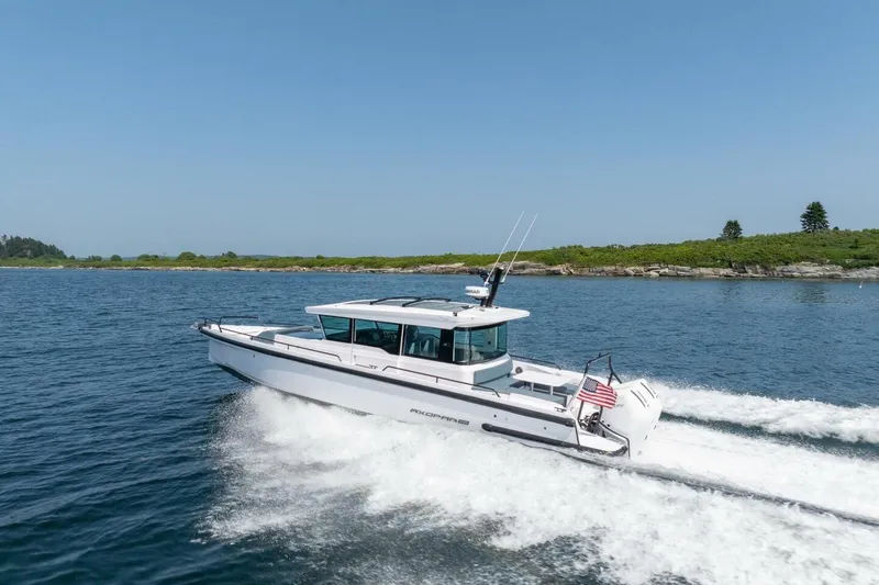 Slide: The Image of 2026 Axopar 37 U-Sofa boat cruising on water. - 2