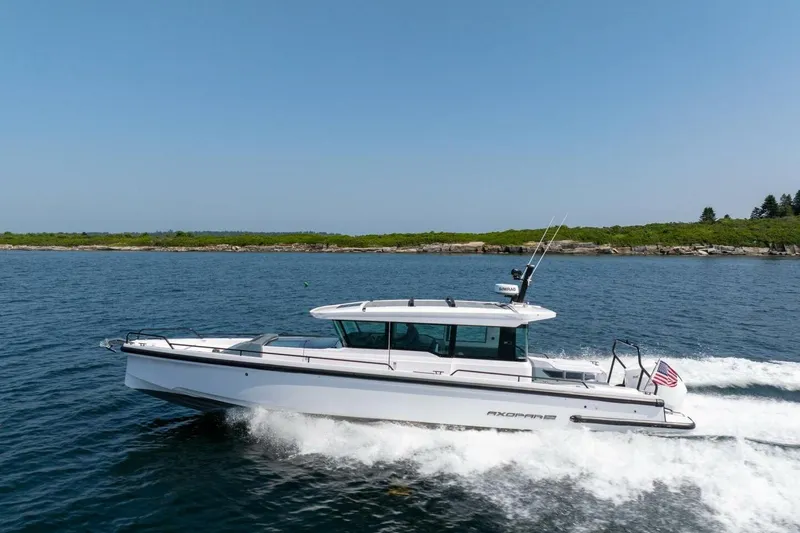 Slide: The Image of 2026 Axopar 37 U-Sofa boat cruising on water. - 3