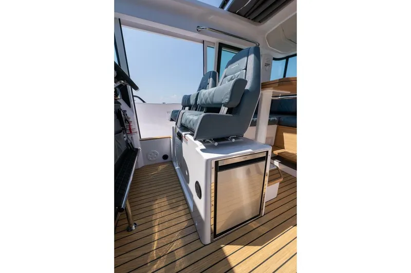 Slide: The Image of Interior of 2026 Axopar 37 U-Sofa with modern seating and refrigerator. - 38