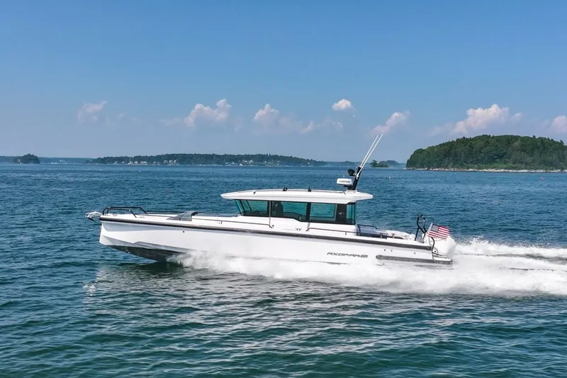 Slide: The Image of 2026 Axopar 37 U-Sofa boat cruising on water in sunny weather. - 6