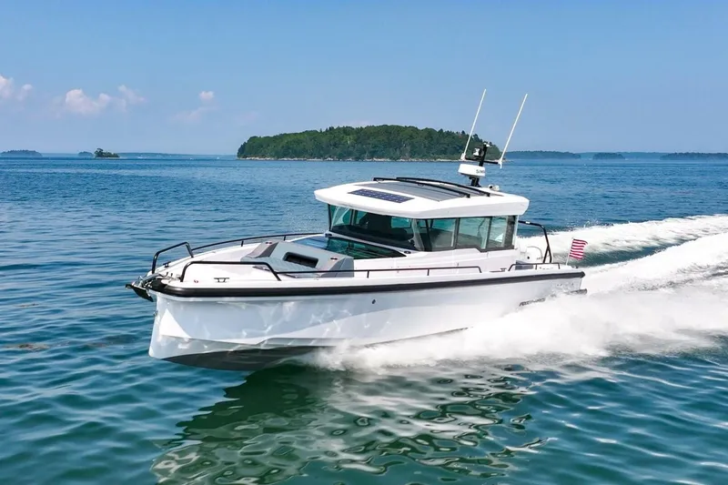 Slide: The Image of Axopar 37 U-Sofa 2026 cruising swiftly on water. - 8