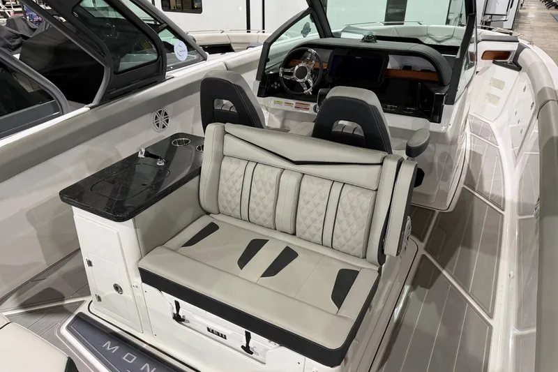 Slide: The Image of 2026 Monterey Elite 30 OB boat displayed indoors at a boat show. - 11
