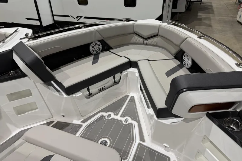 Slide: The Image of 2026 Monterey Elite 30 OB boat interior at indoor exhibition, showcasing luxury seating and design. - 13