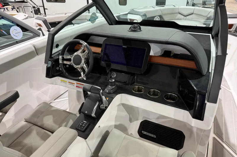 Slide: The Image of 2026 Monterey Elite 30 OB boat dashboard with modern steering and touchscreen display. - 4