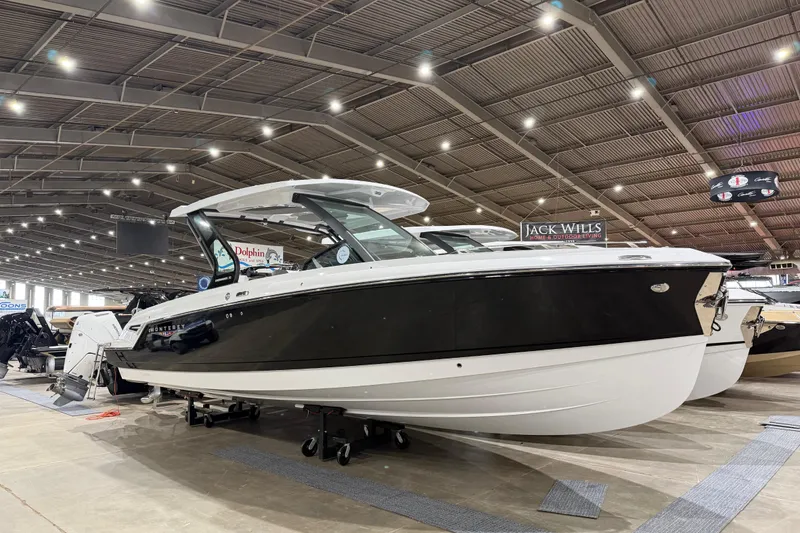 Slide: The Image of 2026 Monterey Elite 30 OB boat on trailer in sunny parking lot. - 9