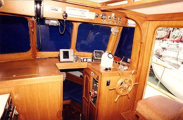 Slide: The Image of Interior of 1979 CHB Double Cabin Trawler with wood paneling and navigation equipment. - 4