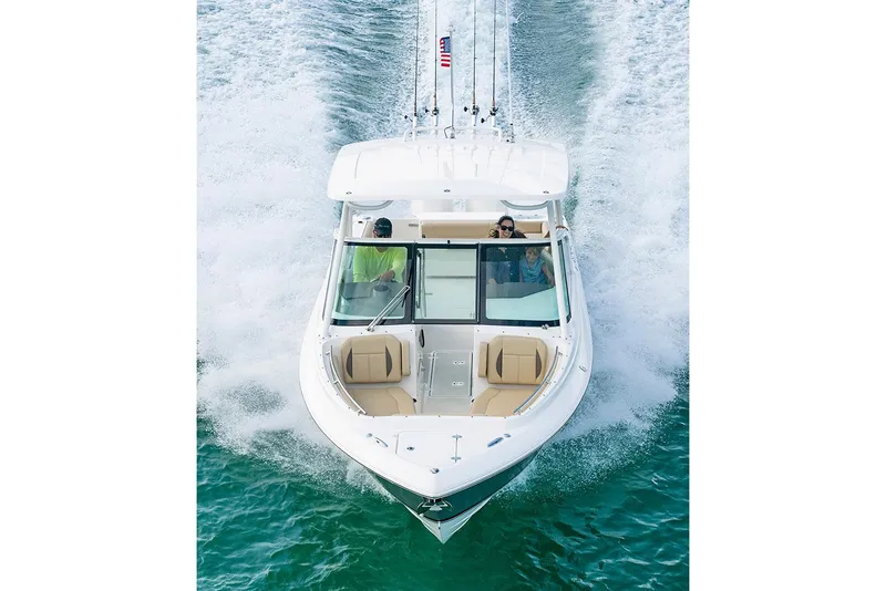 Slide: The Image of Manufacturer Provided Image: 2025 Pursuit DC 266 Dual Console boat cruising on water. - 2