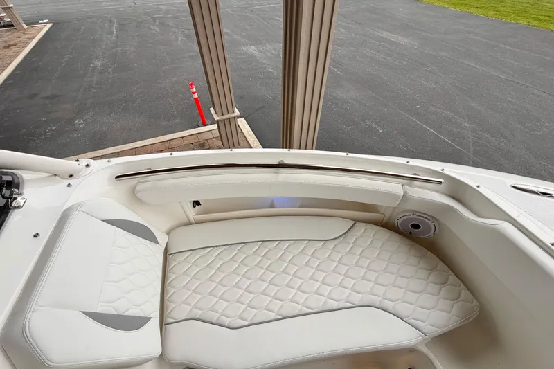 Slide: The Image of 2026 Pursuit DC 266 Dual Console boat with white quilted seating and speaker detail. - 24