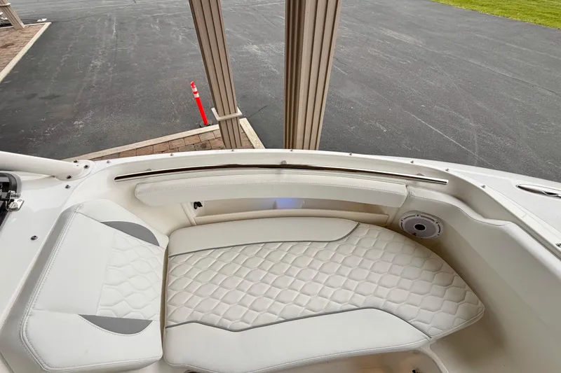 Slide: The Image of 2026 Pursuit DC 266 Dual Console boat interior with white quilted seating. - 25